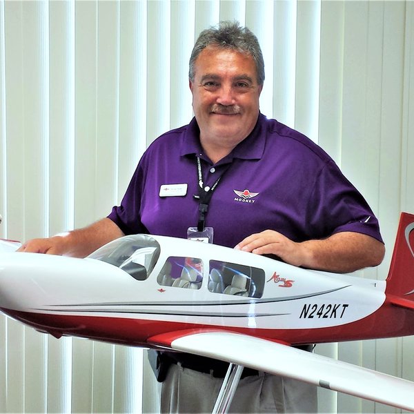 Richard Simile in purple Mooney shirt holding model Acclaim S N242KT